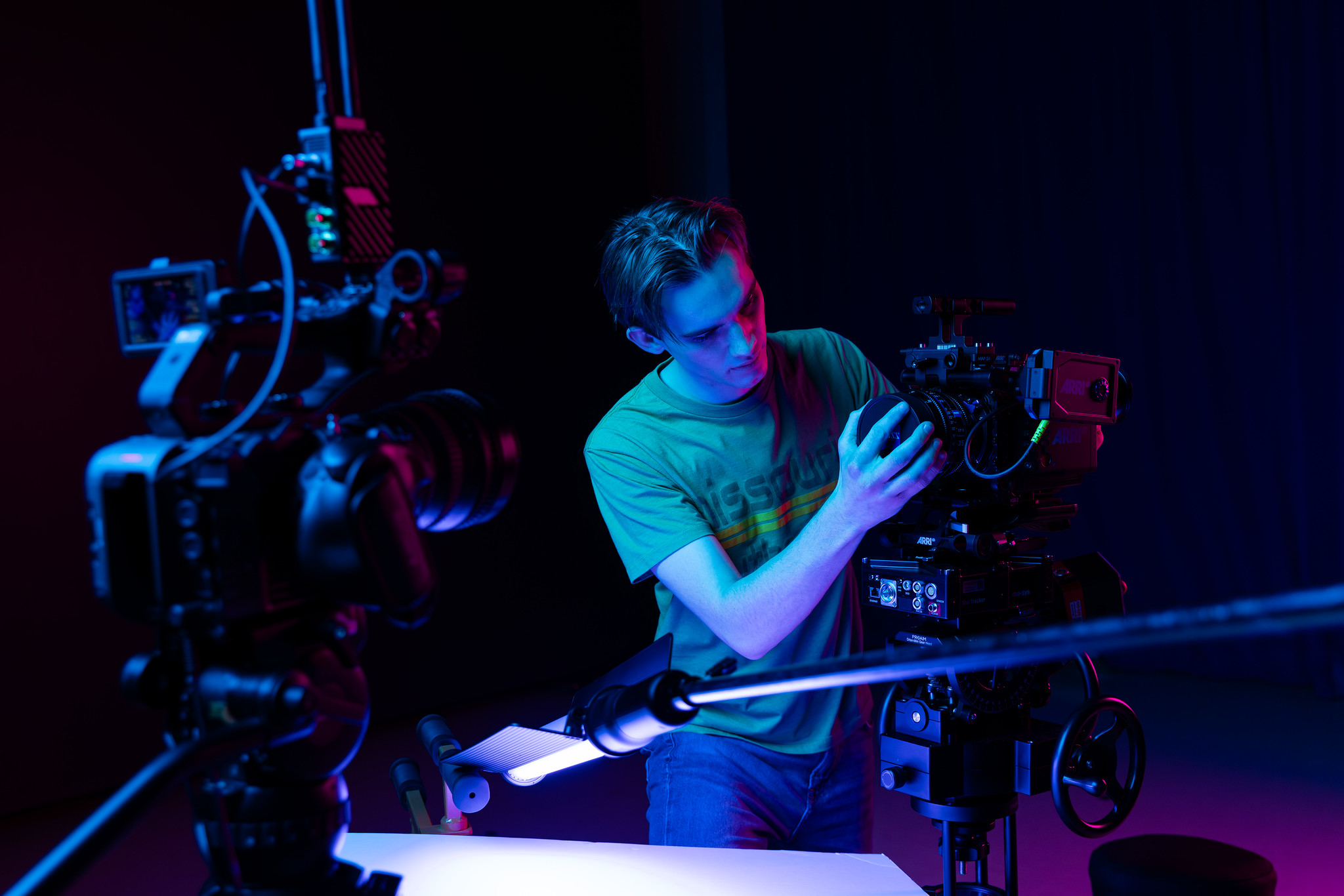 student operating camera in front of LED wall