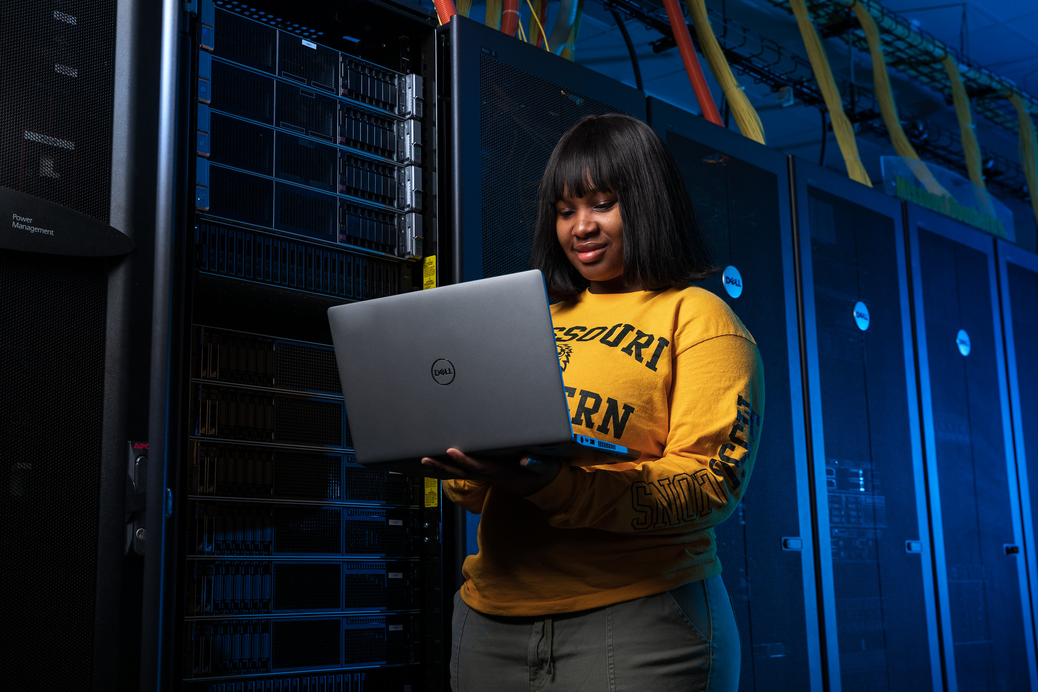 student holding laptop
