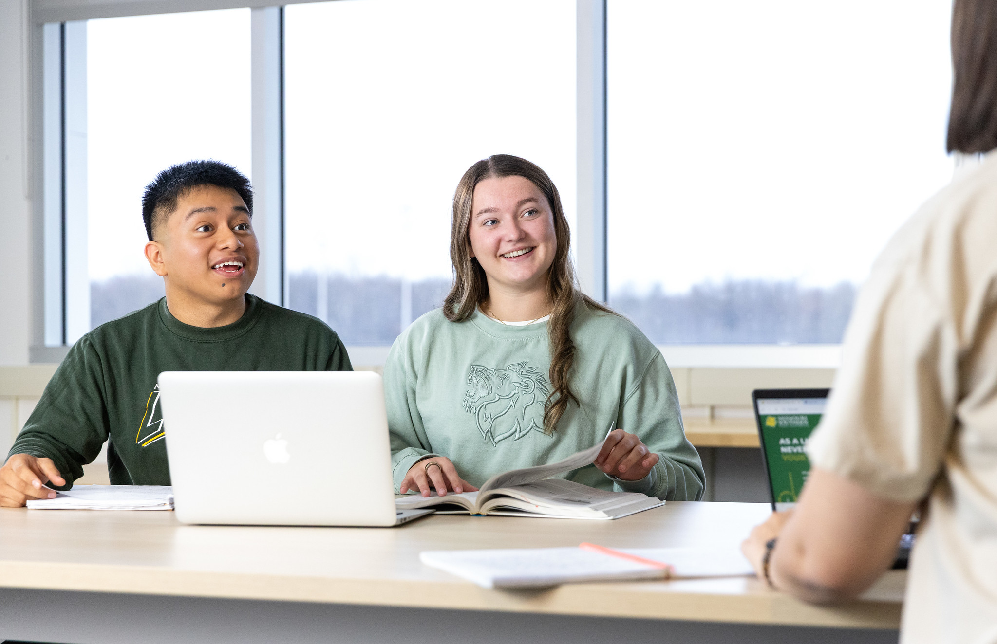 students at a table talking with eachother