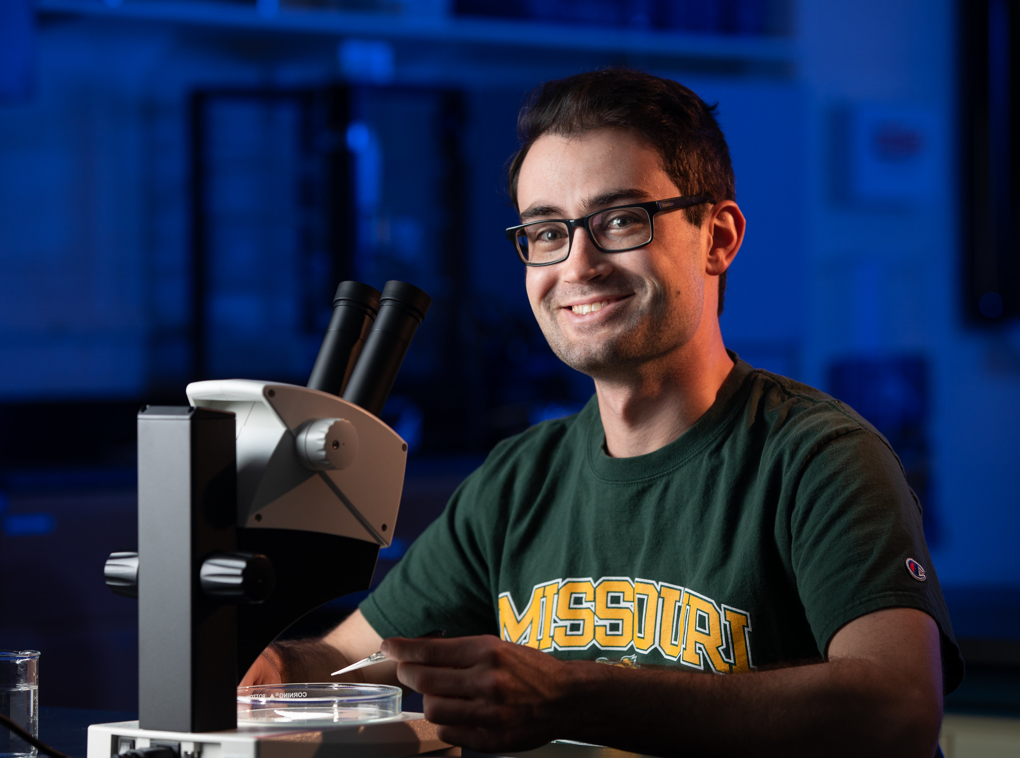 EHS student working in lab with microscope 