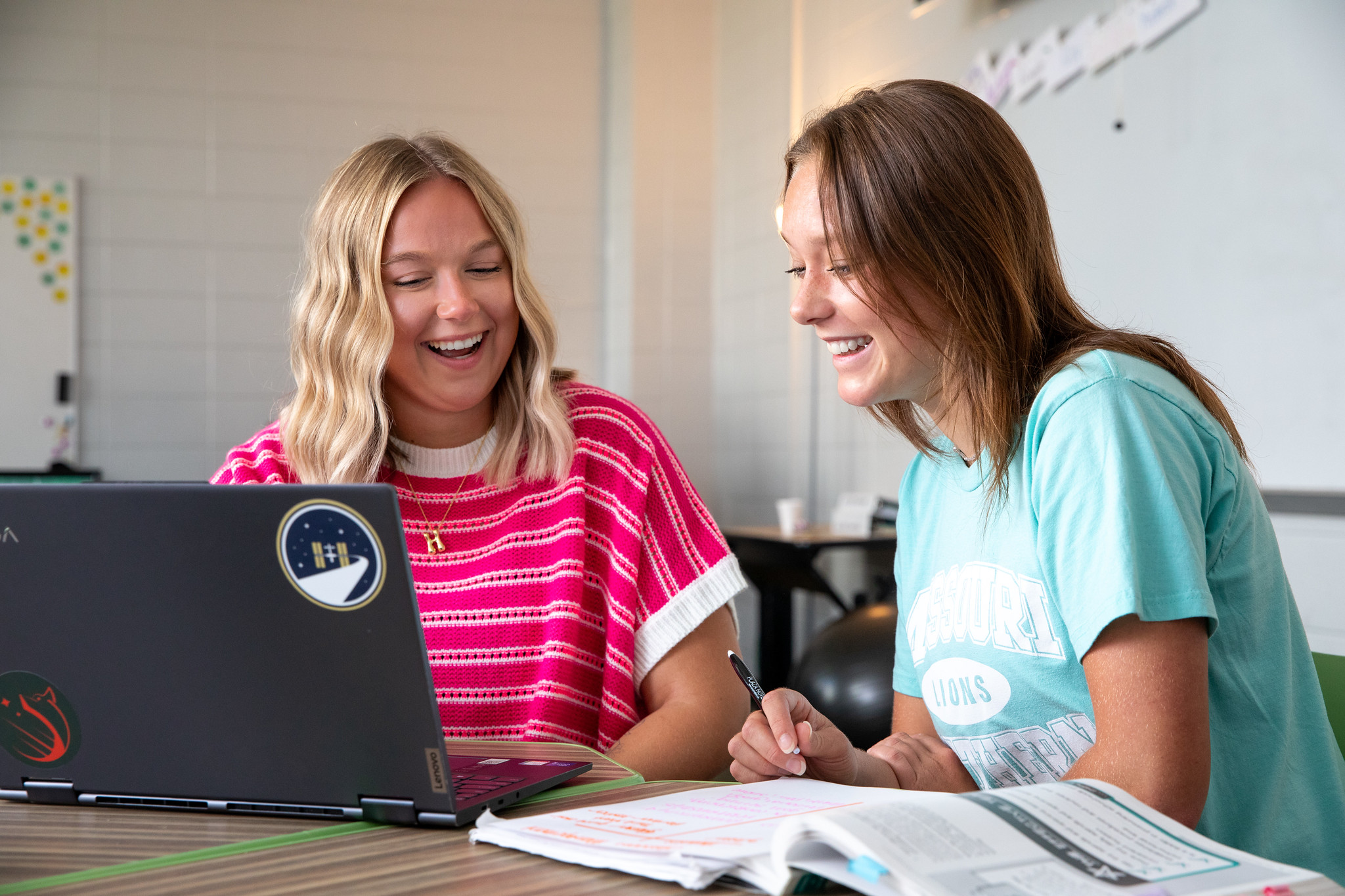 two students studying in classroom