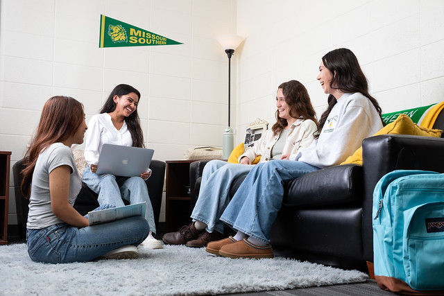 MSSU student relaxing on couches in a common area