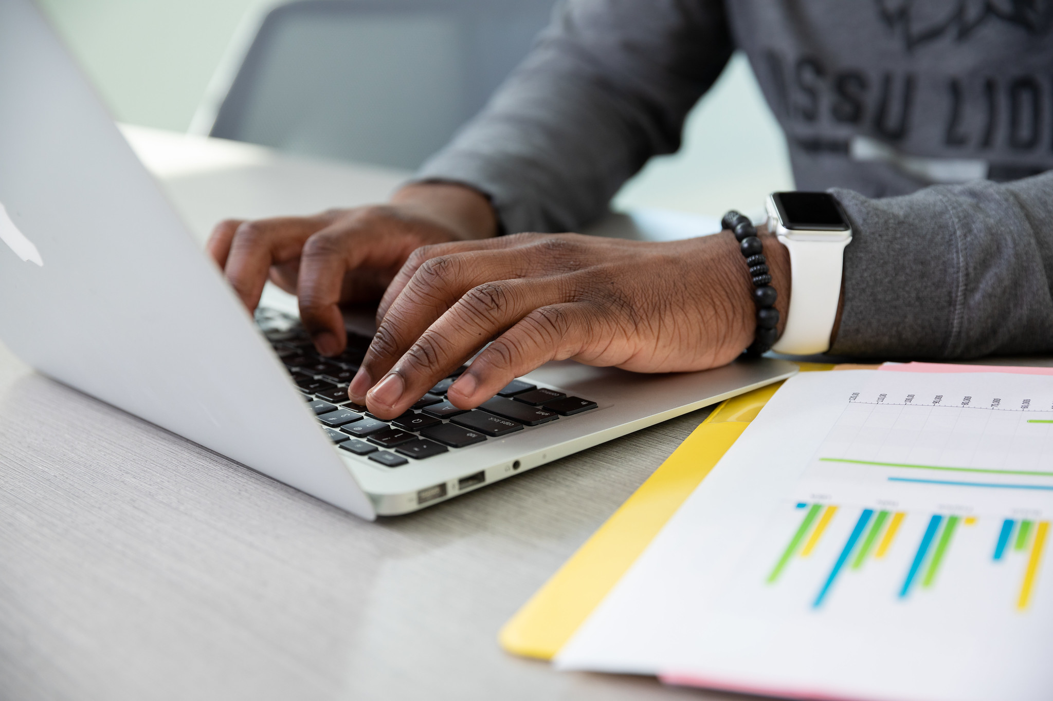 student typing on laptop 