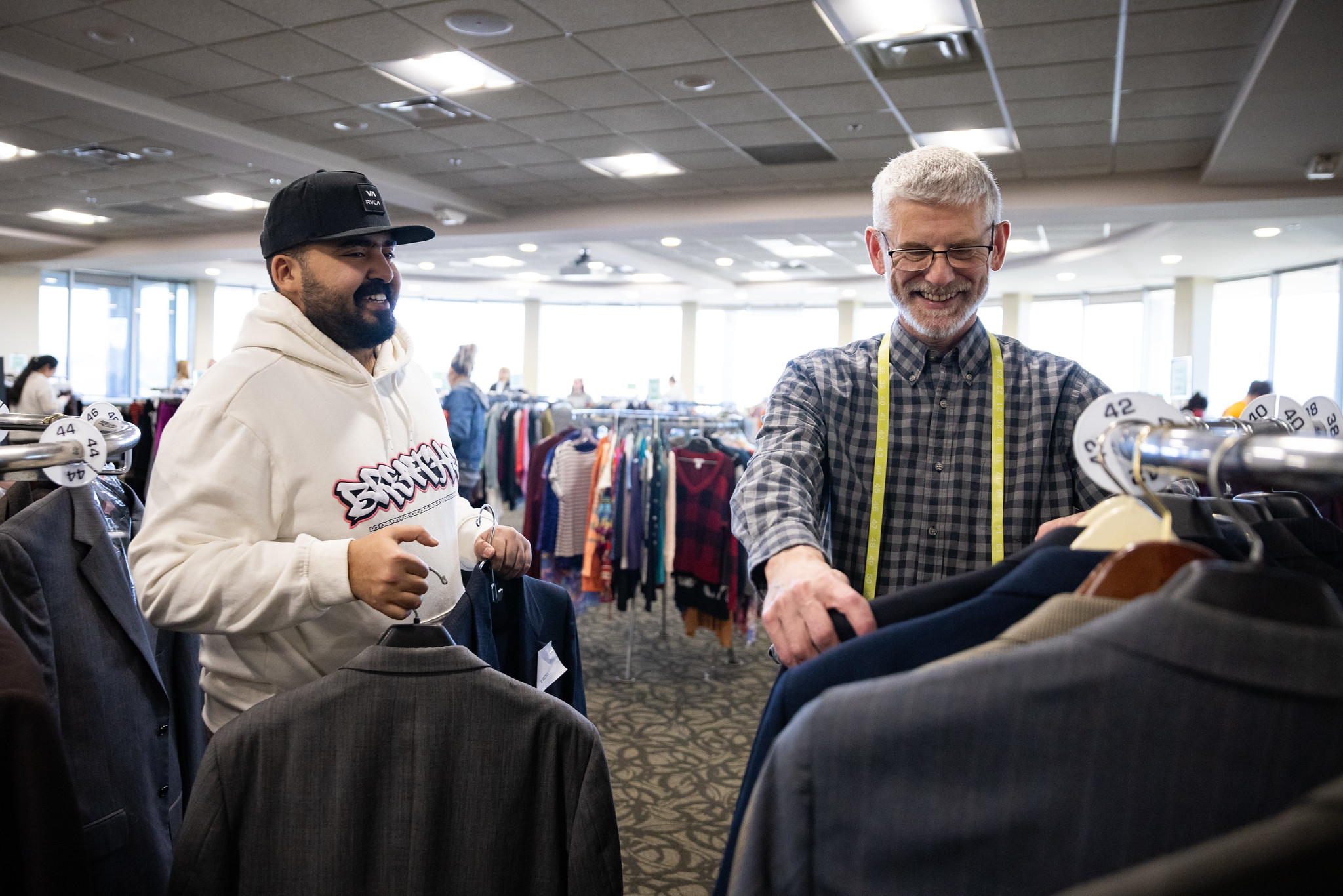 student holding clothes at dress to impress event 