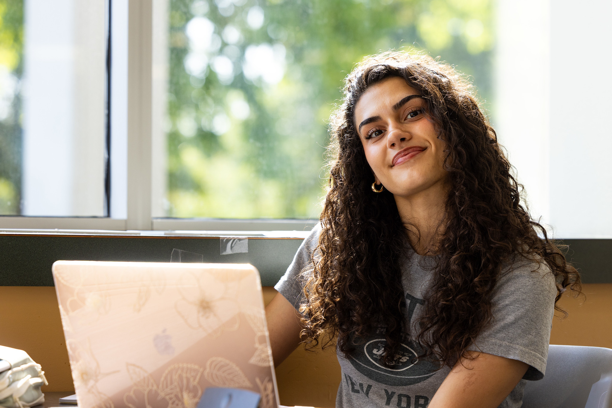 mssu student smiling at laptop 